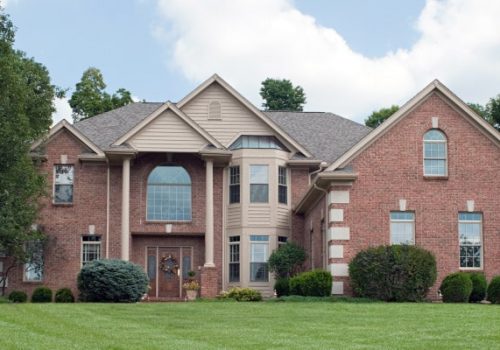 Majestic, modern, red brick house in country estate.