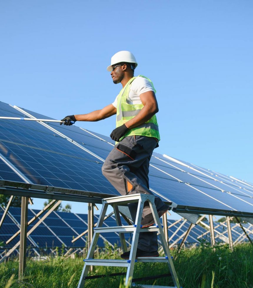 tidy-african-american-worker-is-cleaning-solar-panel