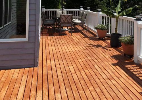 Outdoor home wooden deck patio during lovely summer day with seasonal garden